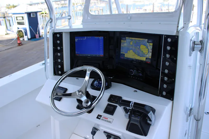  Yacht Photos Pics Control panel of a 1998 Venture 34 Open boat with navigation screens and steering wheel.