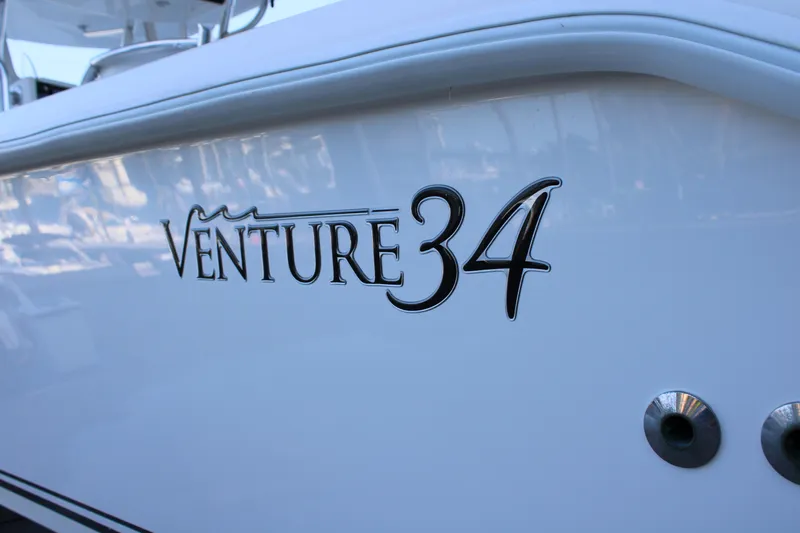  Yacht Photos Pics 1998 Venture 34 Open boat logo on white hull.
