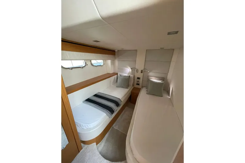  Yacht Photos Pics Luxurious cabin interior of 2012 Sunseeker Manhattan 70 yacht with twin beds and elegant decor.