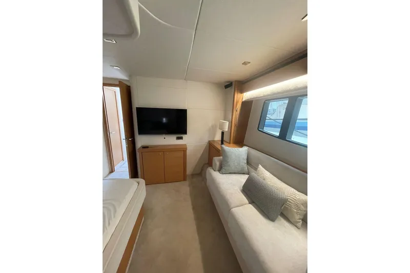  Yacht Photos Pics Luxurious interior of 2012 Sunseeker Manhattan 70 yacht with sofa and TV.