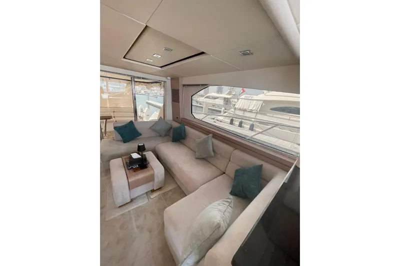  Yacht Photos Pics Luxurious interior of 2012 Sunseeker Manhattan 70 yacht with plush seating and large windows.