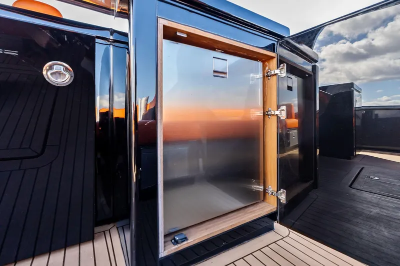 La Do&ntilde;a Yacht Photos Pics Stainless steel cabinet on 2023 Pardo Yachts 50, reflecting sunset and sky.