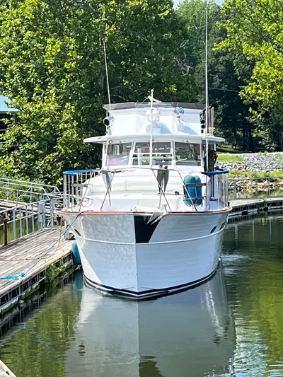  Yacht Photos Pics 1966 Chris-Craft 57 Constellation yacht docked in a serene marina setting.