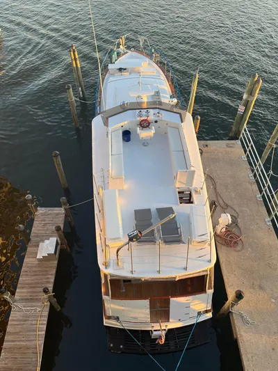  Yacht Photos Pics Aerial view of a 1966 Chris-Craft 57 Constellation yacht docked at a marina.