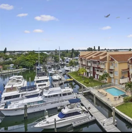  Yacht Photos Pics Marina with Chris-Craft 57 Constellation yacht, 1966, docked near waterfront townhouses and pool.