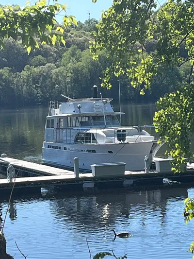  Yacht Photos Pics 1966 Chris-Craft 57 Constellation yacht docked on a serene lake.
