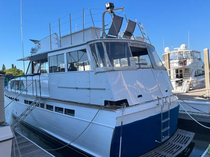  Yacht Photos Pics 1966 Chris-Craft 57 Constellation yacht docked at marina under clear blue sky.
