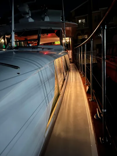  Yacht Photos Pics 1966 Chris-Craft 57 Constellation yacht at night, showcasing sleek deck and polished railings.