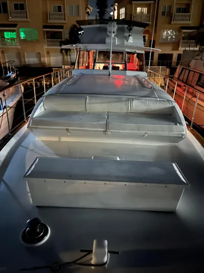  Yacht Photos Pics 1966 Chris-Craft 57 Constellation yacht docked at night, illuminated by soft lighting.