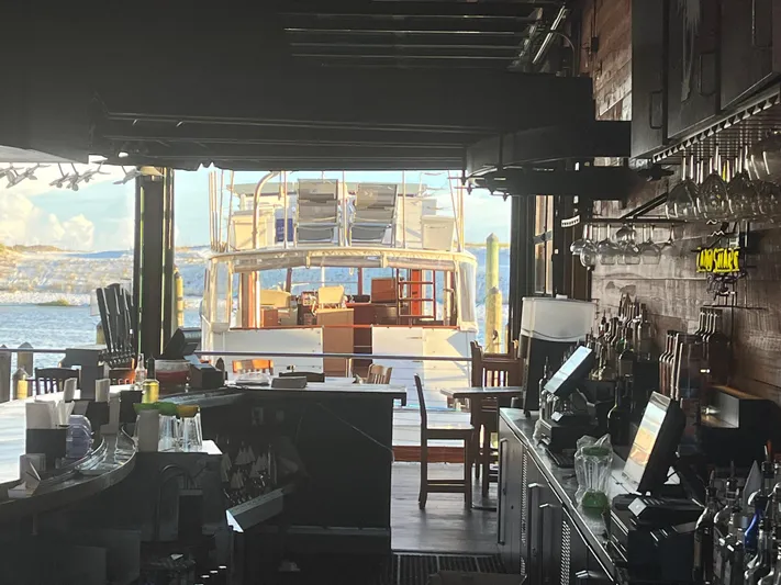  Yacht Photos Pics Bar interior with a view of a 1966 Chris-Craft 57 Constellation yacht docked outside.