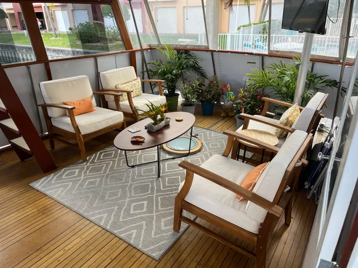  Yacht Photos Pics Luxurious 1966 Chris-Craft 57 Constellation yacht interior with elegant seating and plants.