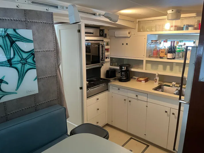  Yacht Photos Pics 1966 Chris-Craft 57 Constellation yacht kitchen with modern appliances and stylish decor.