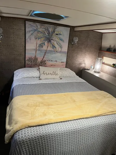  Yacht Photos Pics Cozy bedroom in 1966 Chris-Craft 57 Constellation yacht with beach-themed decor.