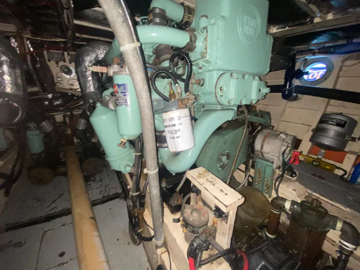  Yacht Photos Pics Engine room of a 1966 Chris-Craft 57 Constellation yacht, showcasing vintage machinery.