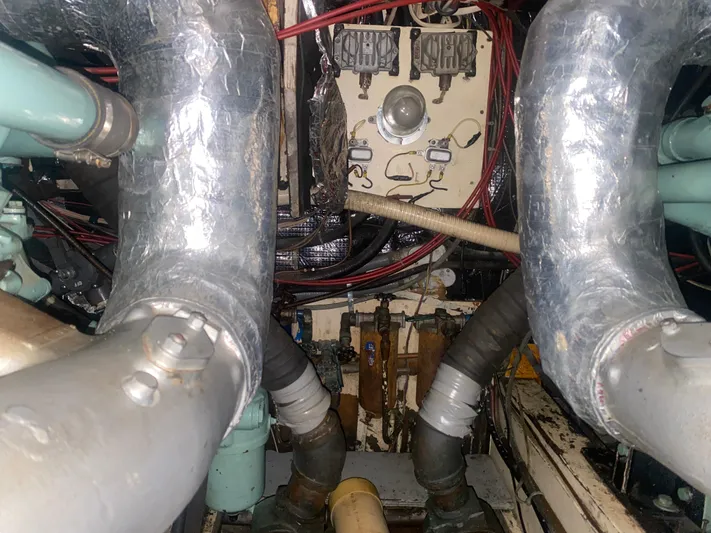 Yacht Photos Pics Engine room of 1966 Chris-Craft 57 Constellation with visible pipes and wiring.