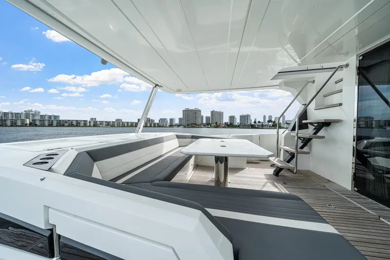 Live More Yacht Photos Pics Luxurious 2021 Galeon 680 Fly yacht deck with seating, table, and city skyline view.