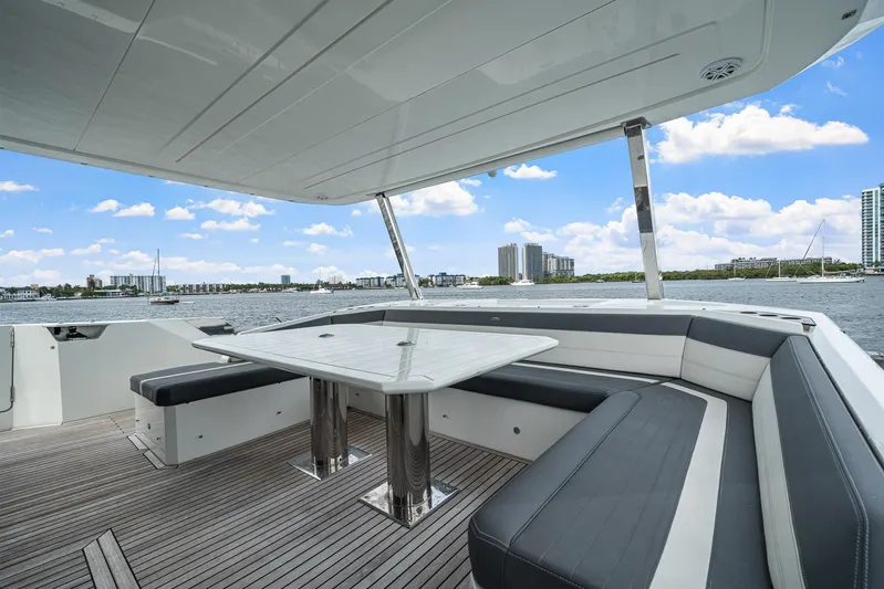 Live More Yacht Photos Pics Luxurious 2021 Galeon 680 Fly yacht deck with seating, overlooking a scenic waterfront view.