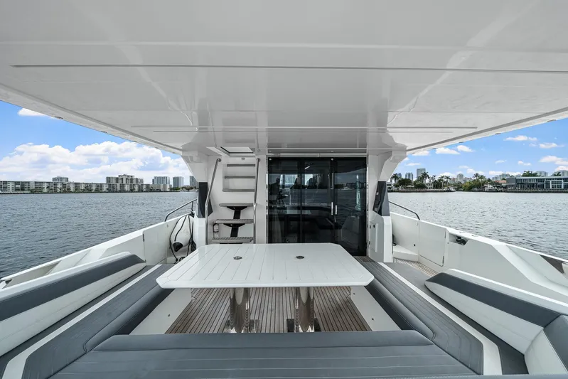 Live More Yacht Photos Pics Luxurious 2021 Galeon 680 Fly yacht deck with seating, table, and waterfront view.