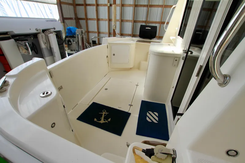  Yacht Photos Pics Interior view of 2011 Fathom Element 43 boat, featuring spacious deck and nautical decor.