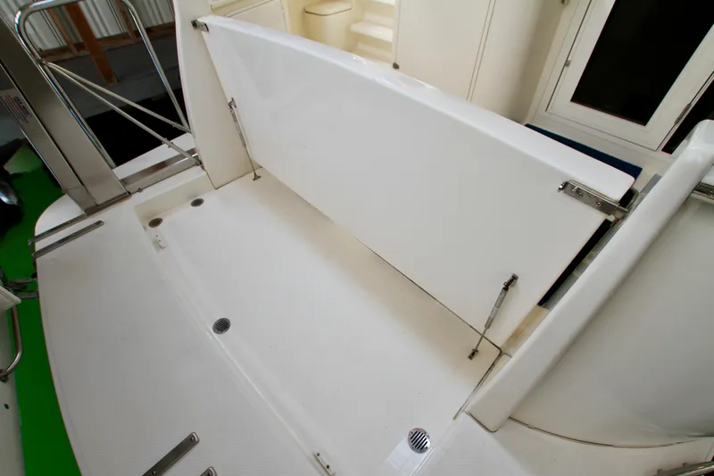  Yacht Photos Pics 2011 Fathom Element 43 boat deck with foldable seating and stainless steel railings.