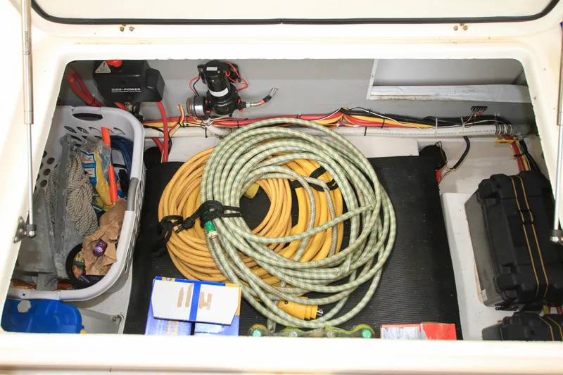  Yacht Photos Pics Storage compartment of 2011 Fathom Element 43 with hoses, cables, and supplies.
