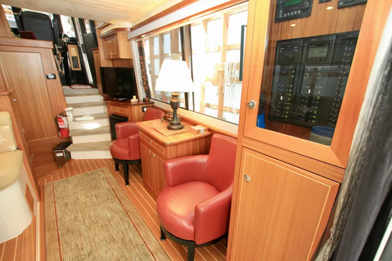  Yacht Photos Pics Luxurious interior of 2011 Fathom Element 43 yacht with wood paneling and red leather chairs.