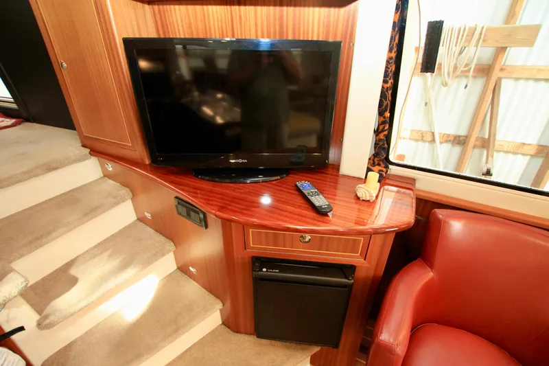  Yacht Photos Pics Interior of 2011 Fathom Element 43 with TV, remote, and red chair.