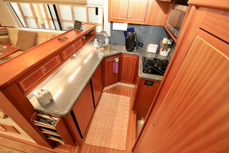  Yacht Photos Pics Luxurious 2011 Fathom Element 43 yacht kitchen with wood cabinetry and modern appliances.