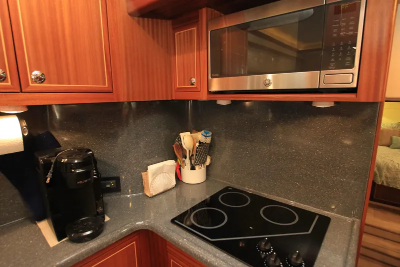  Yacht Photos Pics Compact kitchen in 2011 Fathom Element 43 with microwave, stovetop, and coffee maker.
