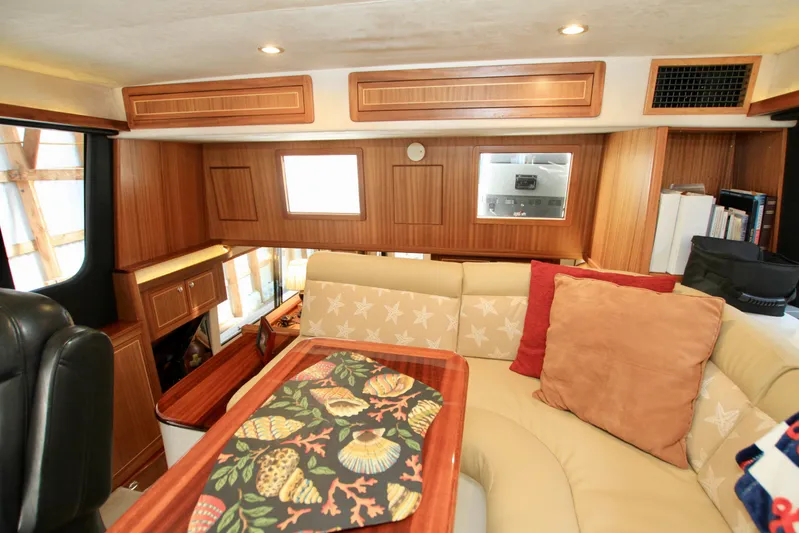 Yacht Photos Pics Luxurious interior of 2011 Fathom Element 43 yacht with wood paneling and cozy seating.