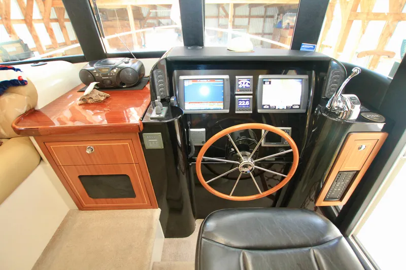  Yacht Photos Pics 2011 Fathom Element 43 yacht helm with navigation screens and wooden steering wheel.