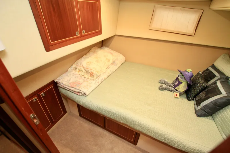  Yacht Photos Pics Cozy cabin interior of 2011 Fathom Element 43 with bed and decorative pillows.