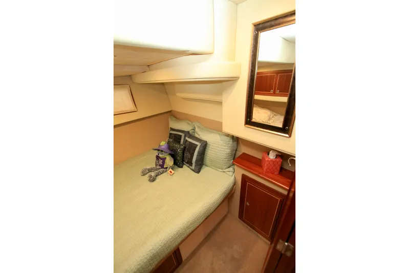  Yacht Photos Pics Cozy cabin interior of 2011 Fathom Element 43 yacht with bed and mirror.