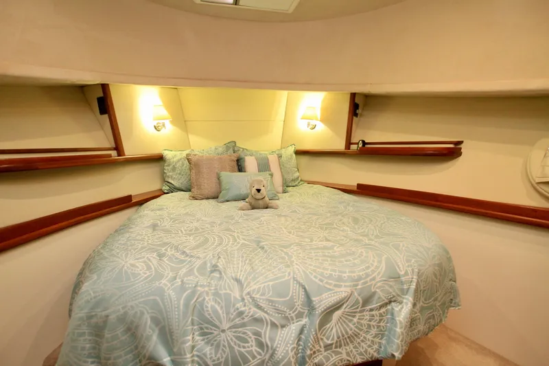  Yacht Photos Pics Cozy bedroom in 2011 Fathom Element 43 yacht with plush bedding and soft lighting.