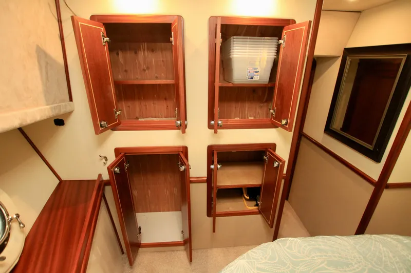  Yacht Photos Pics Wooden cabinets in a 2011 Fathom Element 43 interior, showcasing ample storage space.