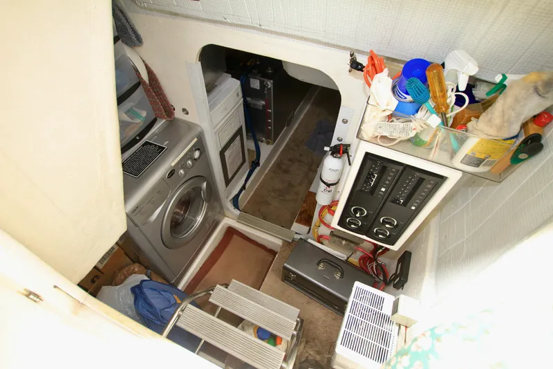  Yacht Photos Pics Laundry area inside 2011 Fathom Element 43 boat with washing machine and storage.