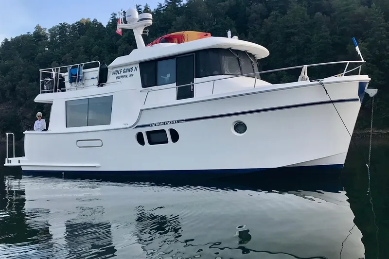  Yacht Photos Pics 2011 Fathom Element 43 yacht on calm water, forested background.