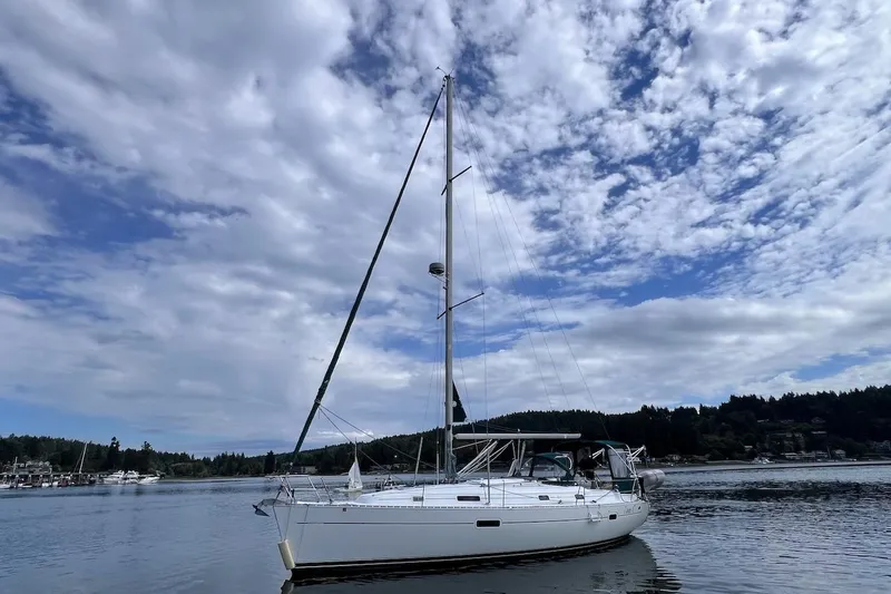 Tina C Yacht Photos Pics 2001 Beneteau 361 sailboat on calm water under a partly cloudy sky.