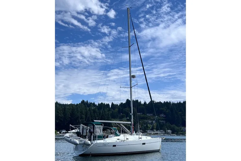 Tina C Yacht Photos Pics 2001 Beneteau 361 sailboat on calm water under a partly cloudy sky.