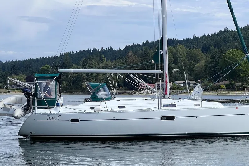 Tina C Yacht Photos Pics 2001 Beneteau 361 sailboat on calm water, forested shoreline in background.