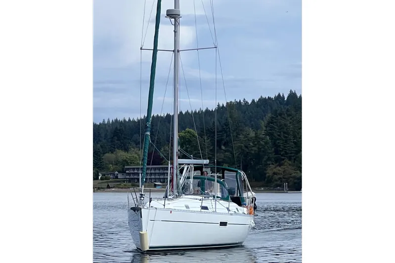 Tina C Yacht Photos Pics 2001 Beneteau 361 sailboat on calm water with forested shoreline background.