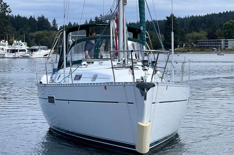 Tina C Yacht Photos Pics 2001 Beneteau 361 sailboat on calm water, surrounded by forested shoreline.