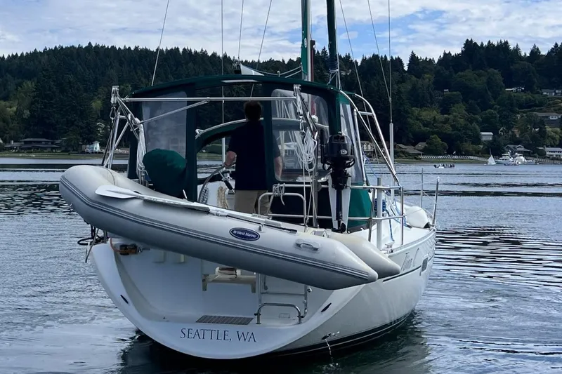 Tina C Yacht Photos Pics Beneteau 361 sailboat from 2001 on water in Seattle, WA, with inflatable dinghy attached.