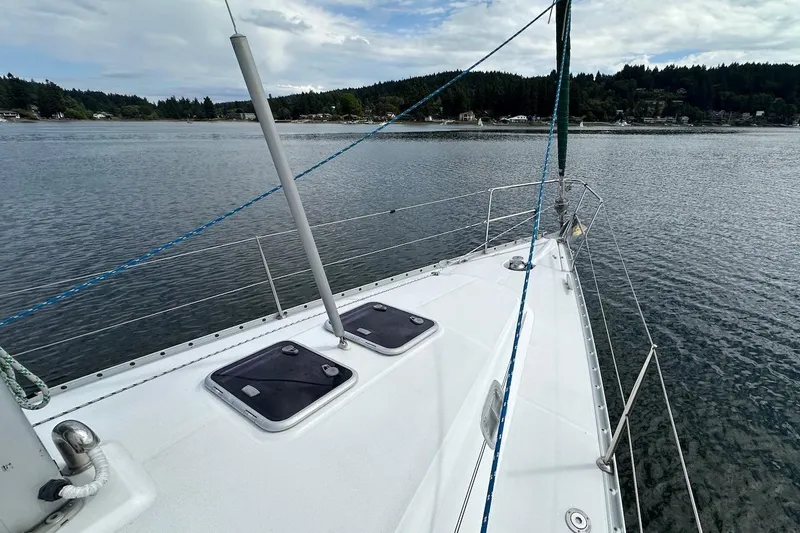 Tina C Yacht Photos Pics 2001 Beneteau 361 sailboat deck with scenic water and forested shoreline.