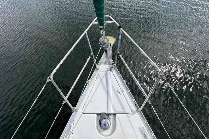 Tina C Yacht Photos Pics Bow of 2001 Beneteau 361 sailboat on calm water, featuring stainless steel railings.