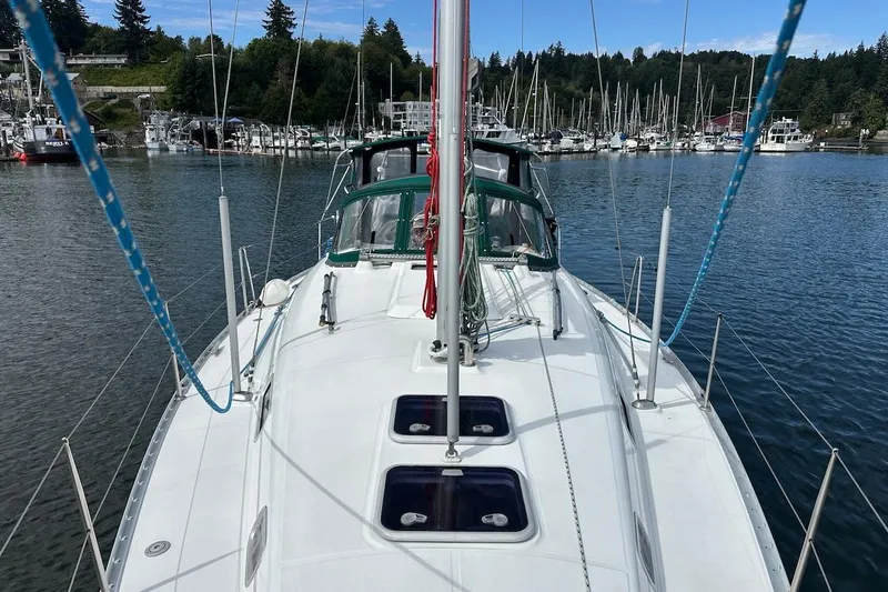 Tina C Yacht Photos Pics Sailboat Beneteau 361, 2001 model, docked in a marina with surrounding boats and trees.