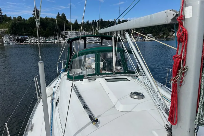 Tina C Yacht Photos Pics 2001 Beneteau 361 sailboat docked in a marina, surrounded by water and trees.