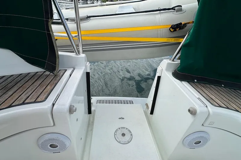 Tina C Yacht Photos Pics Beneteau 361 sailboat stern view with wooden deck and inflatable dinghy, 2001 model.