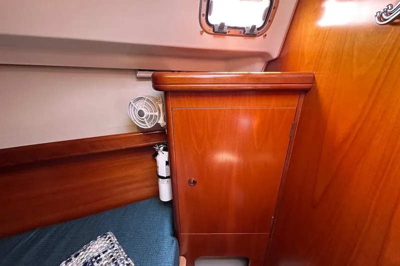Tina C Yacht Photos Pics Interior of 2001 Beneteau 361 sailboat with wooden cabinetry and small fan.