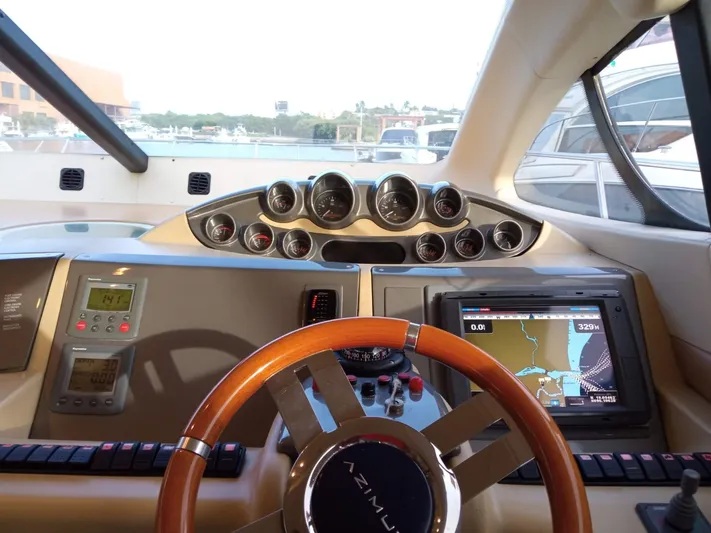  Yacht Photos Pics 2008 Azimut Flybridge yacht helm with navigation system and wooden steering wheel.